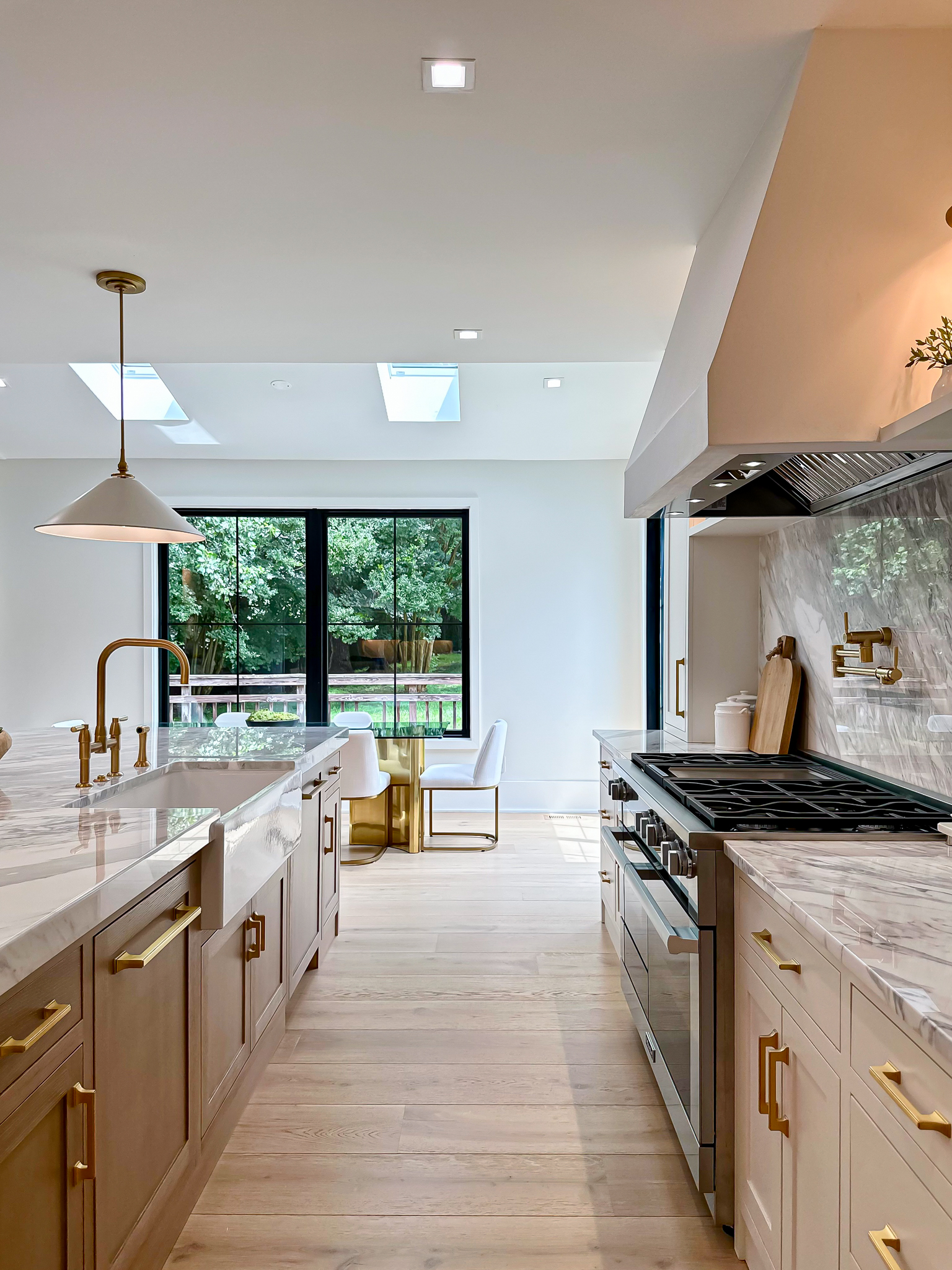 Warm modern kitchen with gold fixtures and natural light